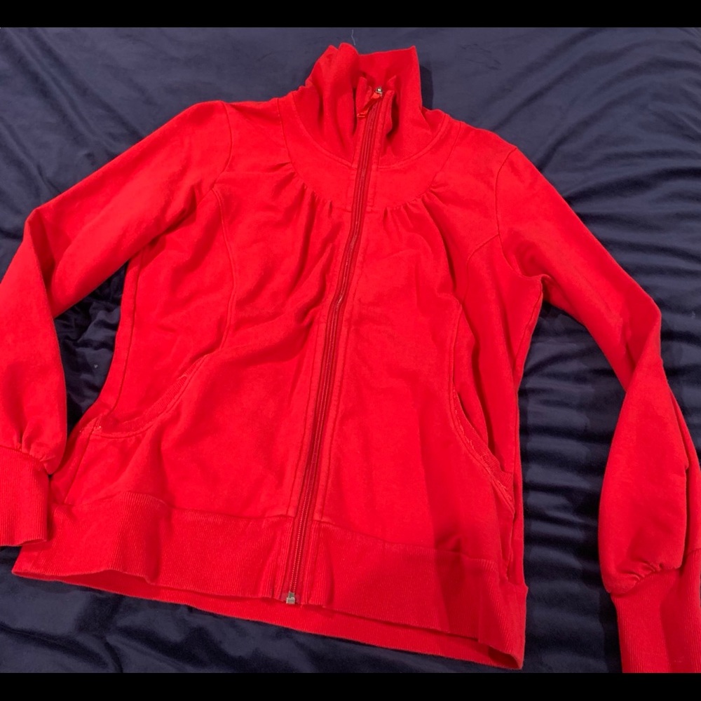 This is a cutter and buck, zip up, it is bright red and it has pockets.